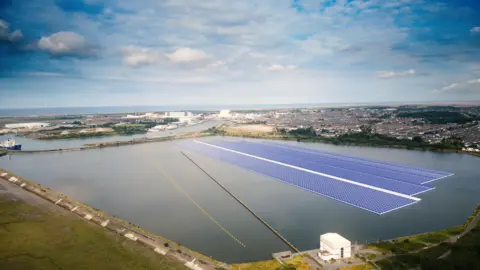 ABP A CGI of how the floating solar farm will look. Three large strips of blue panels are floating across a large section of Cavendish Dock. A town made up of many houses can be seen in the distance. 