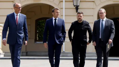 Reuters German Chancellor Friedrich Merz, French President Emmanuel Macron, Ukranian President Voloydmyr Zelensky, and British Prime Minister Keir Starmer walk in the grounds of the Mariynsky Palace, in Kyiv, Ukraine.