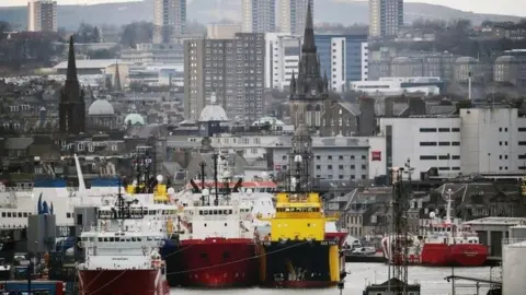 Getty Images An image of Aberdeen harbour, with the granite buildings of the city in the background and ships moored in the harbour in the foreground