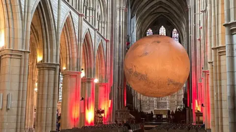 BBC A huge model of Mars hanging from the roof of Truro Cathedral