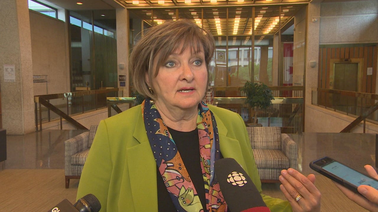 A woman speaks into a microphone.