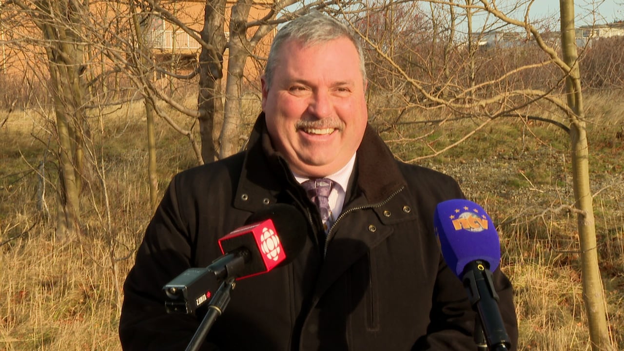 Man standing in front of two microphones