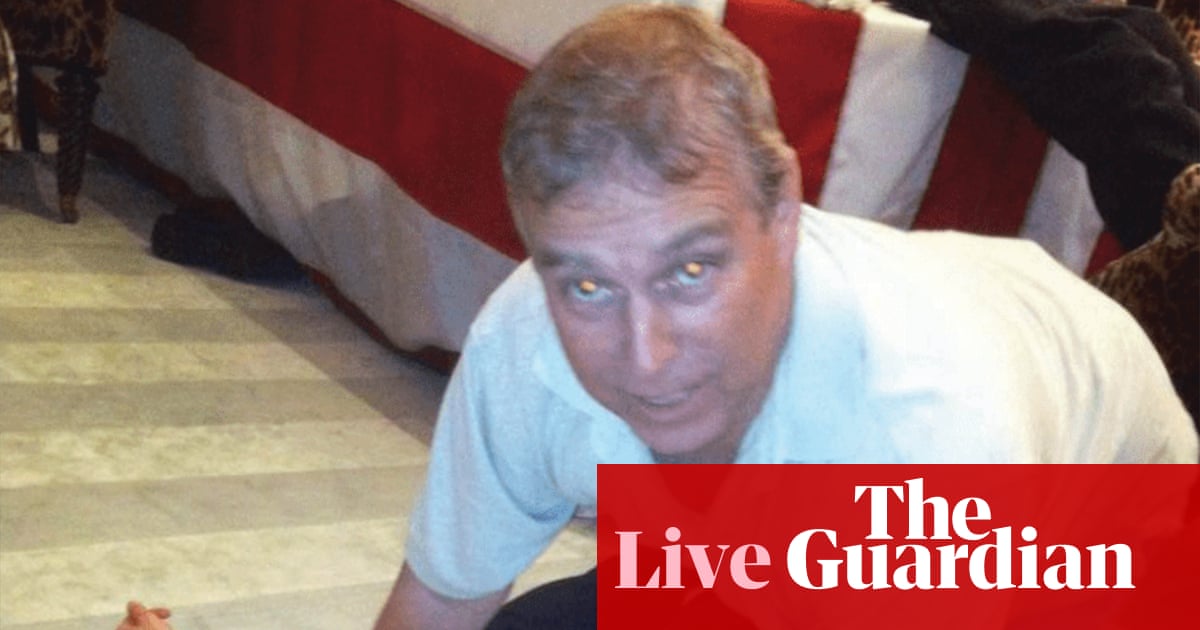 Epstein files latest: photos appear to show former prince Andrew crouching over female | Jeffrey Epstein