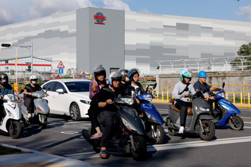Commuters drive past the Taiwan Semiconductor Manufacturing Company's fabrication plant in Kaohsiung, Taiwan, on June 7, 2025. TSMC shares hit record highs in 2025.