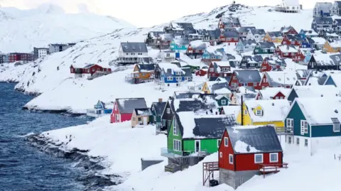 Reuters Colourful little houses stand amid lots of snow next to some water