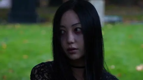 Eternal Rin Eternal Rin is looking over her shoulder with a bleak expression. She is wearing a black lace top and a field of grass can be seen behind her. 