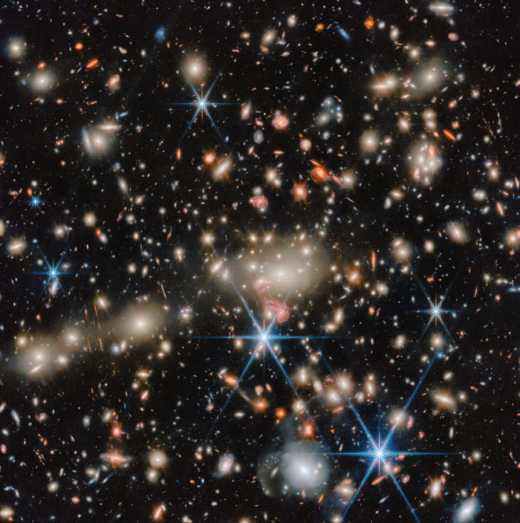 Webb Sees Lensing Galaxy Cluster in Leo
