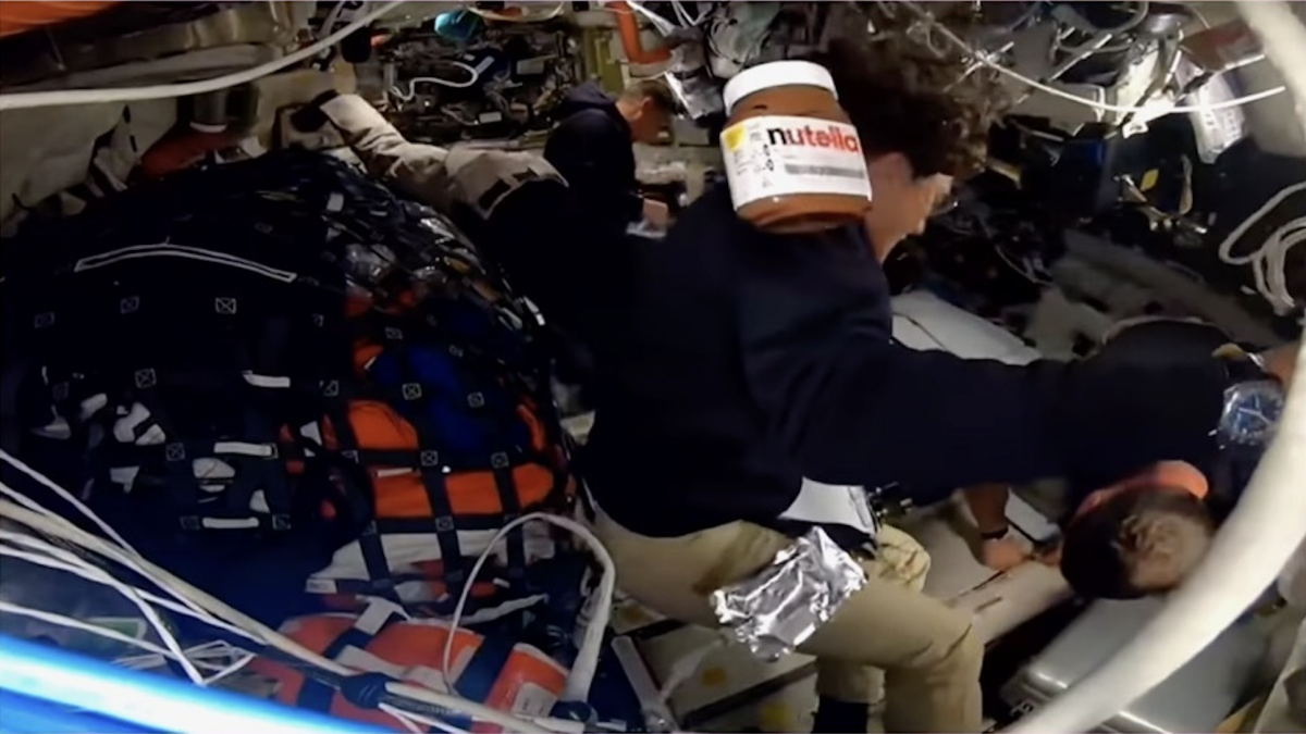 A Nutella jar floats through zero-g with Artemis II crew